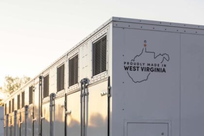 A grid-scale battery stands against a clear sky.