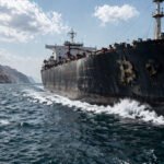 Security team monitors blockchain flows on large screens as a digital lock blocks stolen funds, reflecting crypto’s shift from censorship resistance to emergency intervention after hackers struck