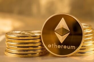 Picture of ethereum coins staked together with one coin stood next to them
